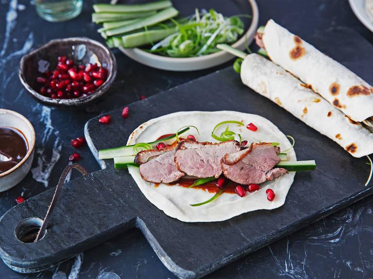 Duck pancakes with cucumber, pomegranate, and hoisin sauce