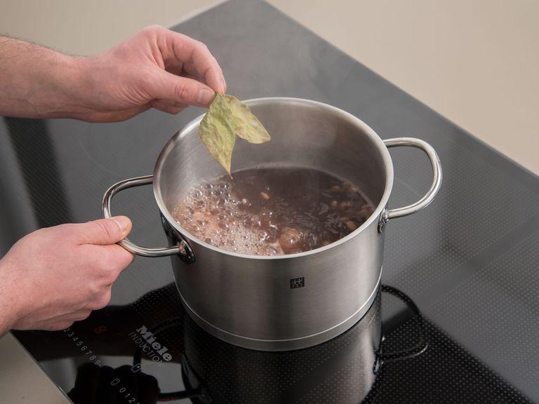 Soak beans in half of the water in a pot overnight. Strain and transfer beans back to the pot the next day. Add the other half of the water and bay leaves to the pot. Simmer over low heat for approx. 40 min .