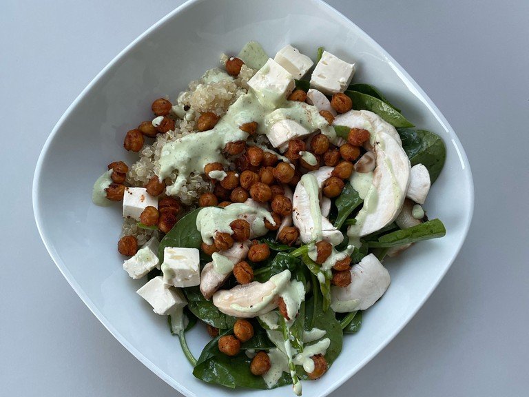 Add the cooked quinoa and spinach & mushroom salad to a bowl. Add the feta cheese you had previously set aside cut in cubes and the crunchy chickpeas. Top it with the lemony feta dressing sauce and enjoy!