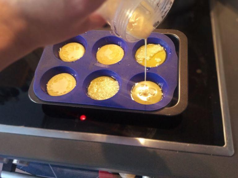 Quickly pour batter into the muffin tin. Each cup should be half full. Quickly return muffin tin to the oven.