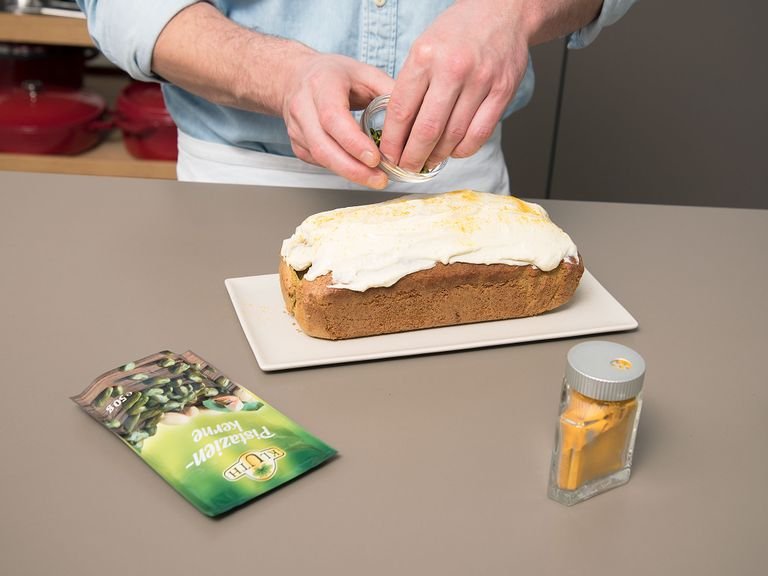 While the cake bakes, add cream cheese, honey, remaining salt, lemon zest, and lemon juice to a small bowl and stir to combine. Frost cooled down cake with cream cheese mixture. Dust with turmeric and sprinkle chopped pistachios on top. Enjoy!