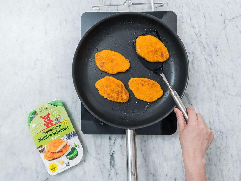 Heat vegetable oil in a large frying pan. Add vegetarian cutlets and fry from each side for approx. 2 – 3 min. Remove from pan and let cool down for 1 – 2 min., then slice each cutlet.