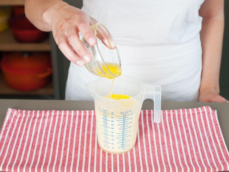 Beat eggs and milk together in another measuring cup, then stir in cooled melted butter until combined.