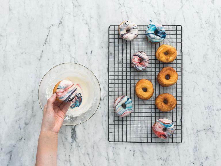 In a large bowl, mix the confectioner’s sugar, cream, vanilla extract, and salt. Add the food coloring and swirl to make a pattern as desired. Dip the top side of the donut into the icing and place it bottom side-down on a wire rack to set. Sprinkle edible glitter over them and enjoy!