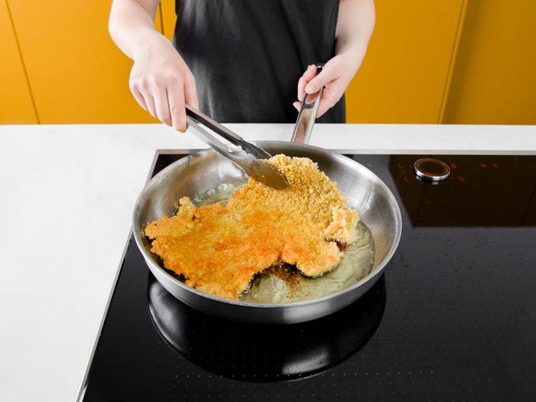 Heat some vegetable oil in a frying pan, then fry the schnitzel on both sides, until crispy and golden. Serve with potato salad and lemon wedges. Enjoy!