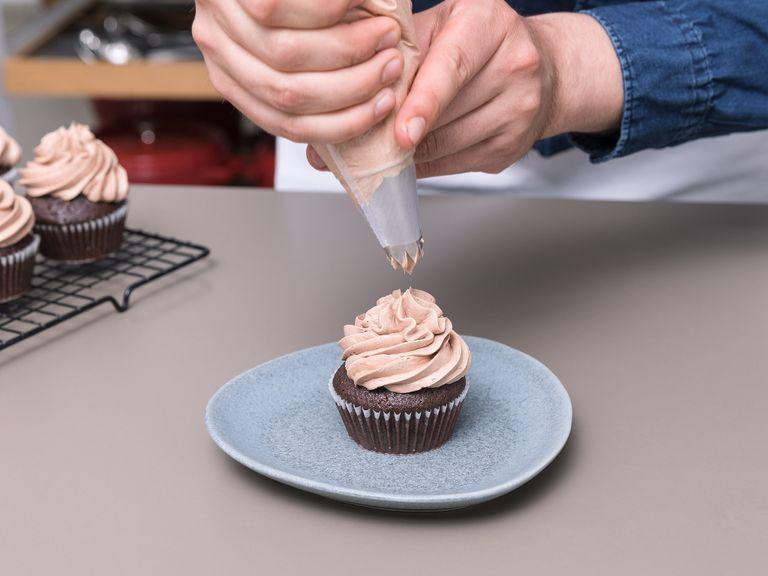 To assemble the cupcakes, use a small spoon to hollow out the middle of the cupcakes, then fill with strawberry jam mixture. Fill chocolate buttercream into a piping bag, and pipe onto the cupcakes with a star-shaped decorating tip. Garnish with the chocolate-covered strawberries. Enjoy!