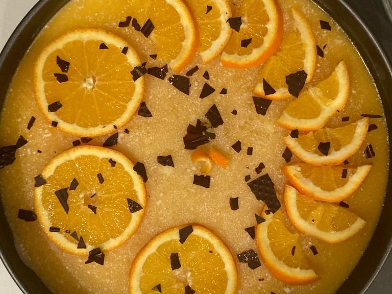 take out the cake from the fridge and slice the orange, with the slices decorate the cake. now enjoy!