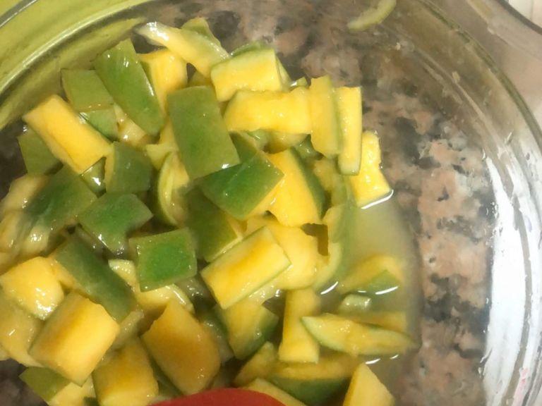 After letting the mangoes brine for about 8 hours, separate the mangoes and the brine solution in separate contains. Add 1 tbsp of apple cider vinegar, mix it well and then start making the pickle spices mix