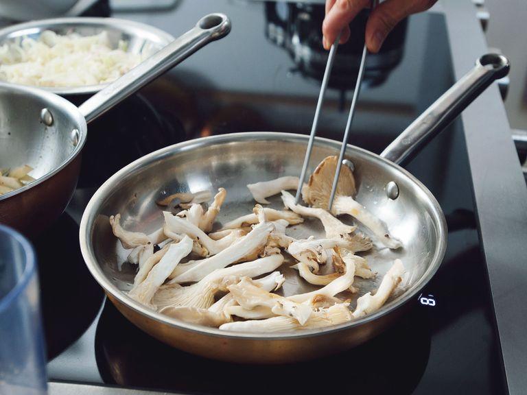 Clean oyster mushrooms and remove blemishes with a paring knife. Heat vegetable oil in a sauté pan over medium-high heat and fry mushrooms until crispy, using tongs to turn them. Season with ground coriander, salt, and pepper.
