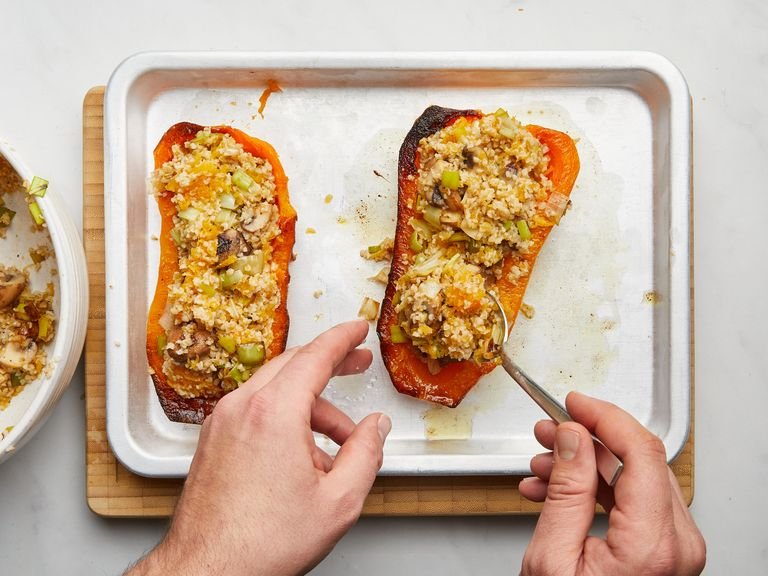 Stuff the butternut with the filling. Sprinkle with breadcrumbs and drizzle with a little olive oil and salt. Then transfer back to the oven and roast again for approx. 10 min., until the top starts to brown slightly. Serve and enjoy!