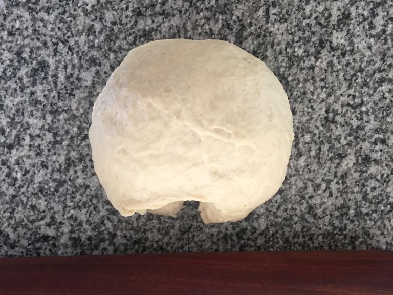 once the dough has risen, cut in half and shape each piece into a ball. (this recipe makes two medium-sized pizzas.)
