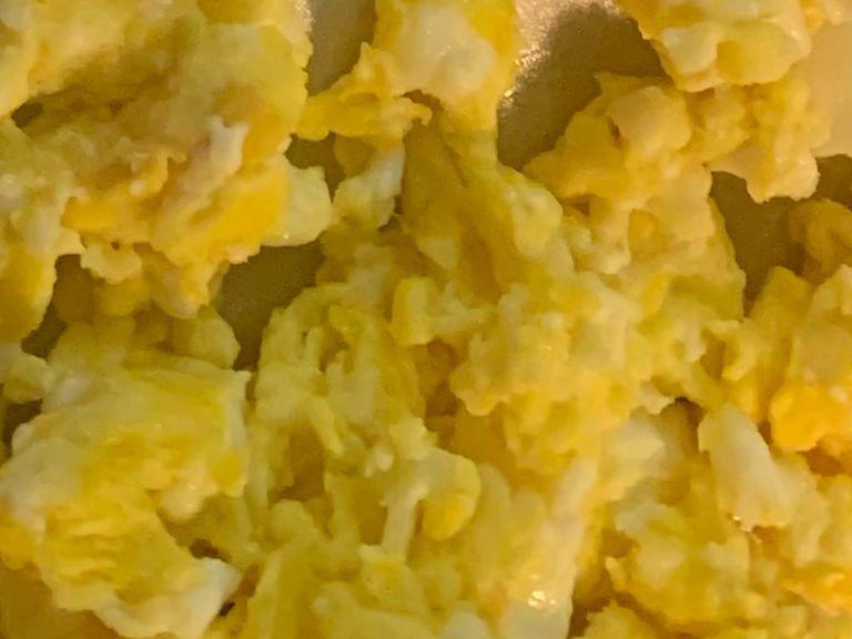 On a medium heat in a separate skillet take a dash of EVOO and bring it up to temperature. Crack 5 eggs into the skillet and scramble them until yellow and fluffy. Set aside.