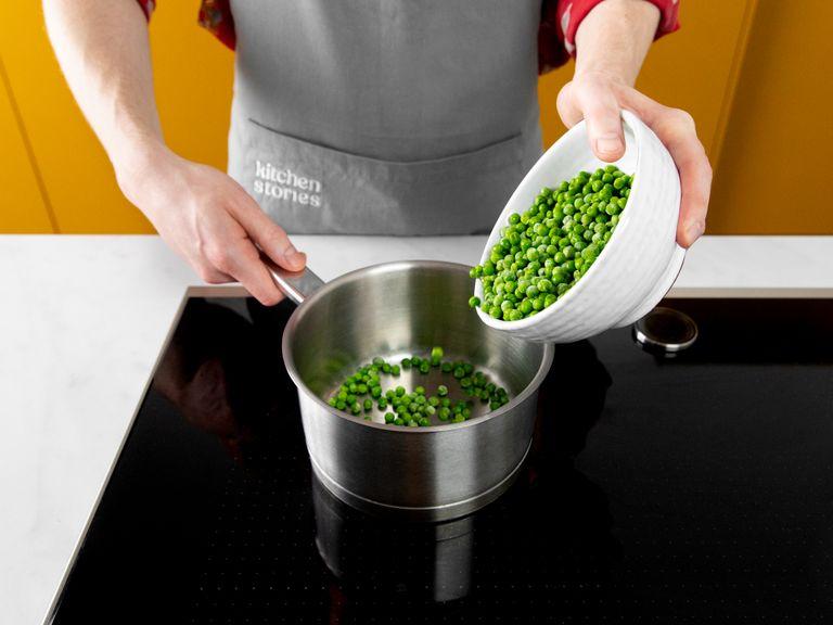Add frozen peas to a saucepan with a splash of water and bring to a boil over a medium heat. With the lid on, let steam for approx. 4 min. Remove from heat, add butter, mint, remaining lemon juice, season with salt and pepper, and lightly mash.