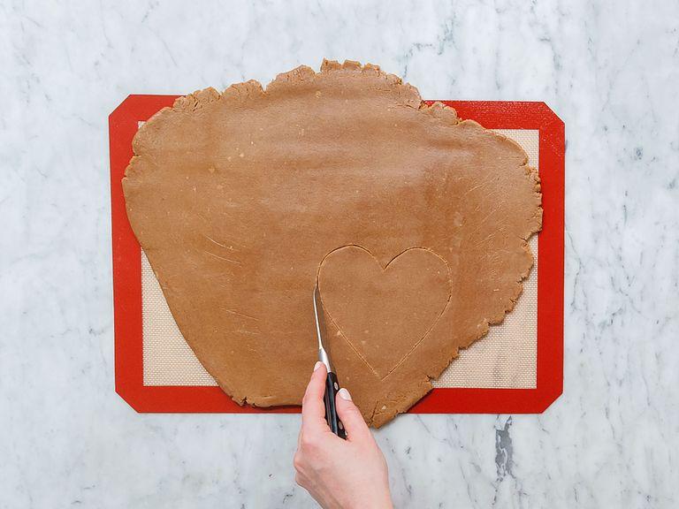 Preheat oven to 200°C/390°F. Roll out dough on a silicone baking mat or in between two sheets of plastic wrap. It should be 1-cm/0.4-in thick. Cut out ten heart-shaped forms and transfer them onto two parchment-lined baking sheets. Bake in the oven for approx. 12 – 15 min. Remove from oven and transfer onto a neutral underground when still warm. Let cool down completely.