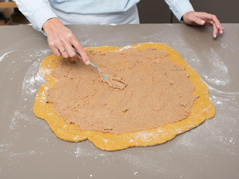 To make the filling, mix butter, cane sugar, and cinnamon. When the dough has risen, turn out of bowl and knead on a floured working surface for approx. 2 – 3 min., or until smooth, then roll into a large rectangle. Spread the cinnamon-sugar mixture on top of the dough.