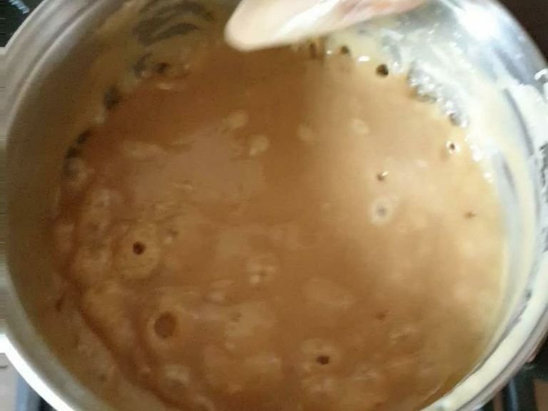 Add the condensed milk and bring to a rapid boil and continue stirring continuously. Cook until the mixture has thickened.