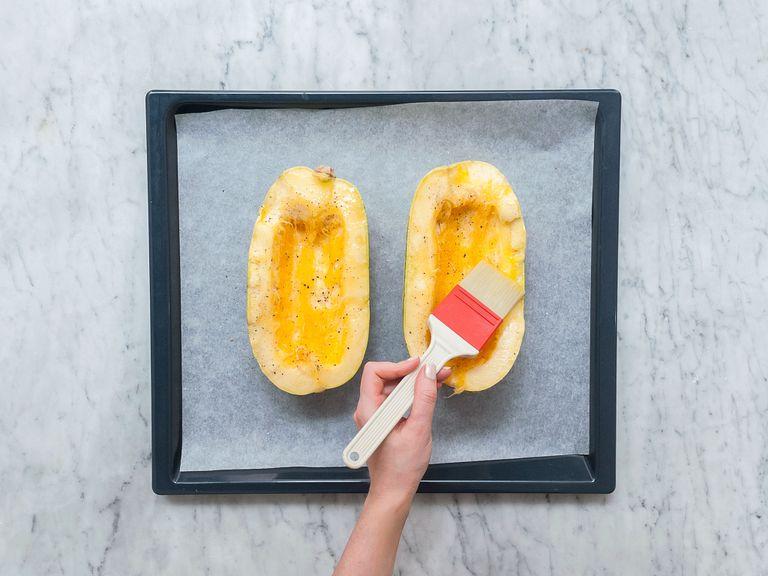 Pre-heat oven to 200°C/390°F. Halve spaghetti squash lengthwise and remove the core with a spoon. Transfer squash to a parchment-lined baking sheet. Brush with olive oil and season with salt and pepper. Bake for approx. 40 min.