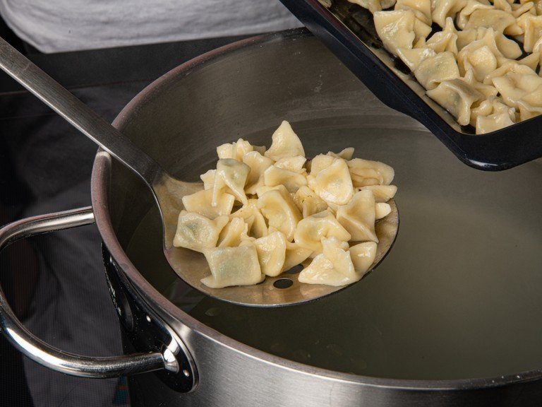 To cook the manti, bring water to a boil in a large pot. Salt generously and transfer the manti to the boiling water in batches. Cook until they float to the top, approx. 5 min. Remove them from the water using a slotted spoon.