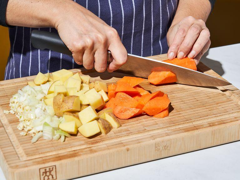 Peel carrots. Dice carrots and potatoes into medium chunks. Dice onion into cubes and mince garlic.