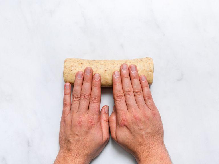 Turn dough onto a work surface and roll into a log of approx. 4 cm/1,5 in. in diameter. Wrap in plastic wrap and let chill in the refrigerator for at least 30 min.
