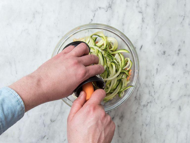 Using a vegetable spiralizer, cut sweet potatoes, carrots, beetroot, and zucchini into spaghetti-like noodles. Add to a large bowl and season with salt and sugar. Let sit for approx. 5 min.