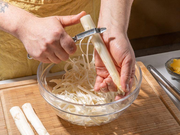 Trim white asparagus to remove the woody ends. Peel, slice lengthwise, and chop into bite size pieces. Finely dice onion.