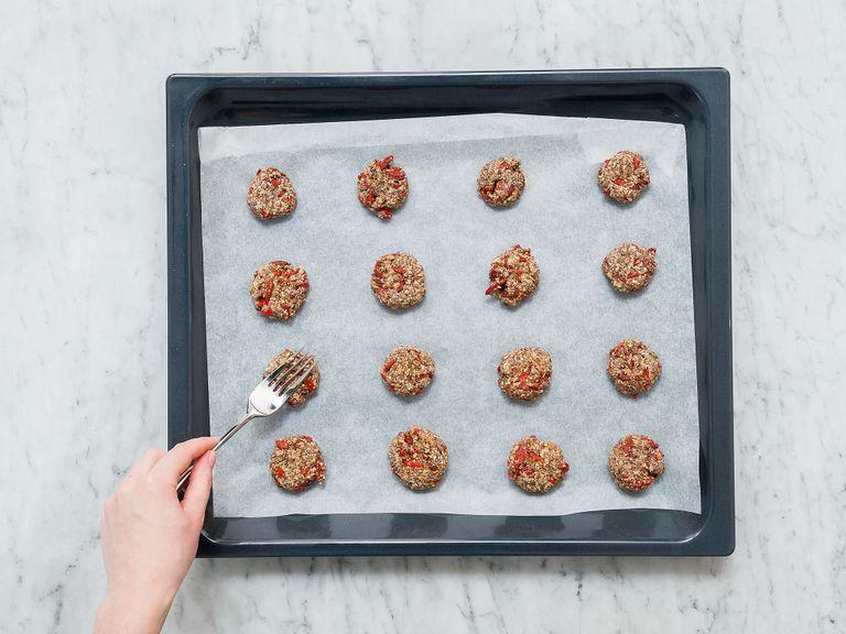 Slightly wet your hands with water. Portion the dough with a teaspoon and roll it with your hands to form small balls. Add to a parchment-lined baking sheet and gently flatten with a fork. Bake at 180°C/350°F on the middle rack for approx. 8 – 10 min. Remove from oven and let cool.