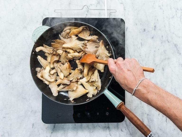 Heat remaining oil in a frying pan. Add oyster mushrooms and fry over medium heat for approx. 8 min. Remove from heat and season with salt to taste.