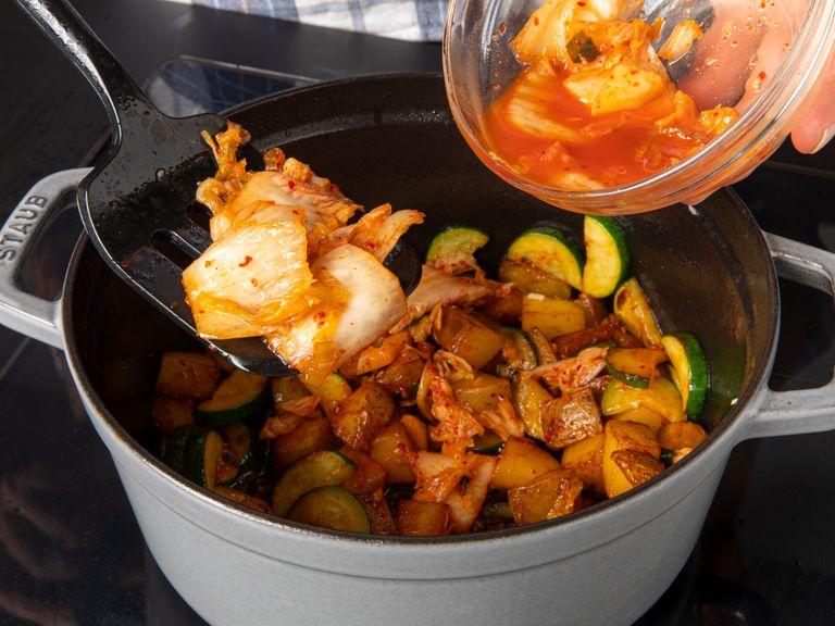 Place a heavy-bottomed pot over medium-high heat. Add vegetable oil and toasted sesame oil. Once hot, add potatoes and stir-fry for approx. 5 min. Add garlic, zucchini, gochujang, and kimchi. Cook for approx. 5 min., or until the gochujang starts to stick to the bottom of the pot.