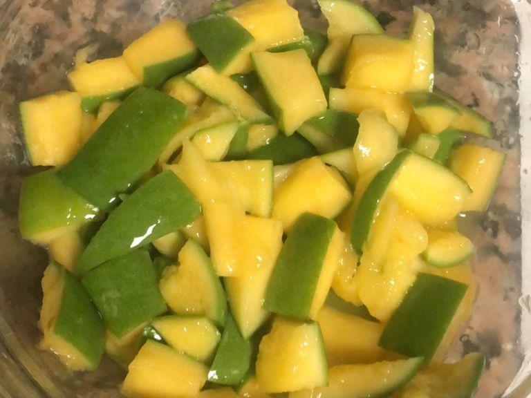 Store the cube sized semi ripe mangos mixed with 1 tbsp of salt in a glass bowl with lid
