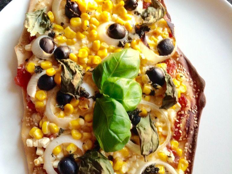Add chopped oregano and some basil leaves for a better look. Now enjoy this very special pizza!