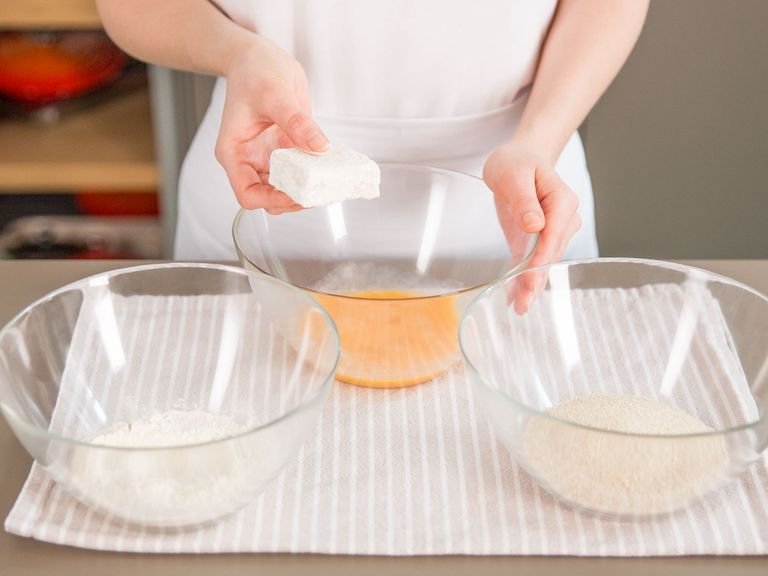 Add flour, beaten eggs, and breadcrumbs each to a separate mixing bowl. Coat milk squares in flour, egg, then breadcrumbs.