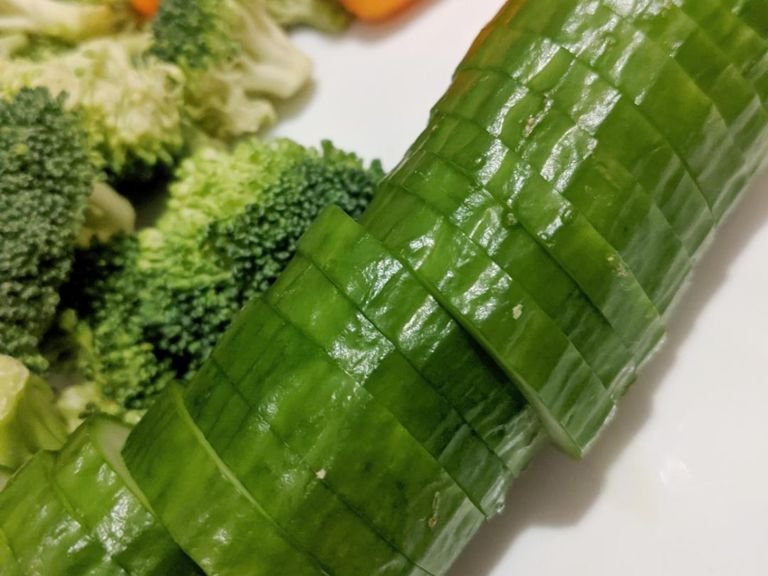 Chop cucumber and broccoli.