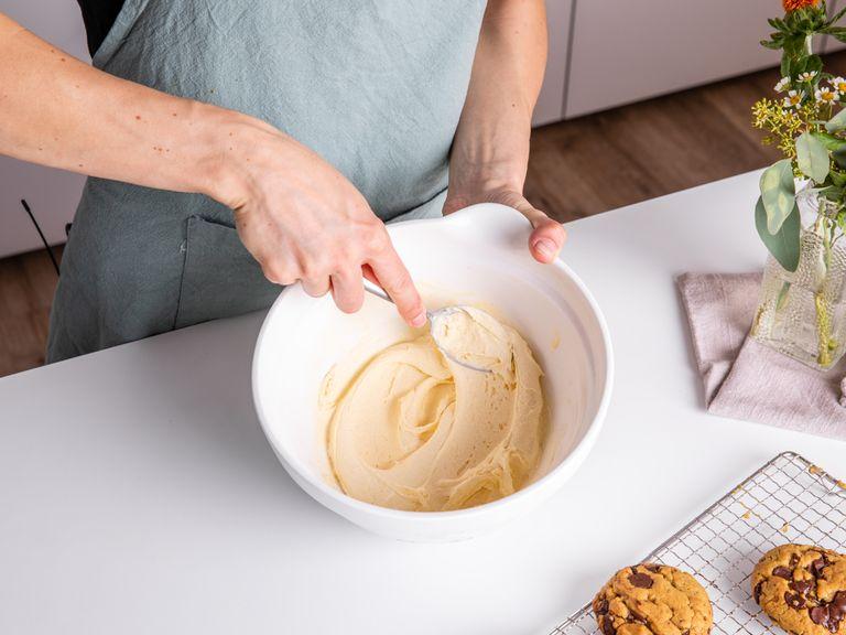 After the cookies have cooled down completely, roughly chop pistachios and transfer them to a plate. Slice the pistachio ice cream into pieces and add to a large bowl. Mash and stir with a wooden spoon until creamy. Work quickly so the ice cream doesn’t melt.