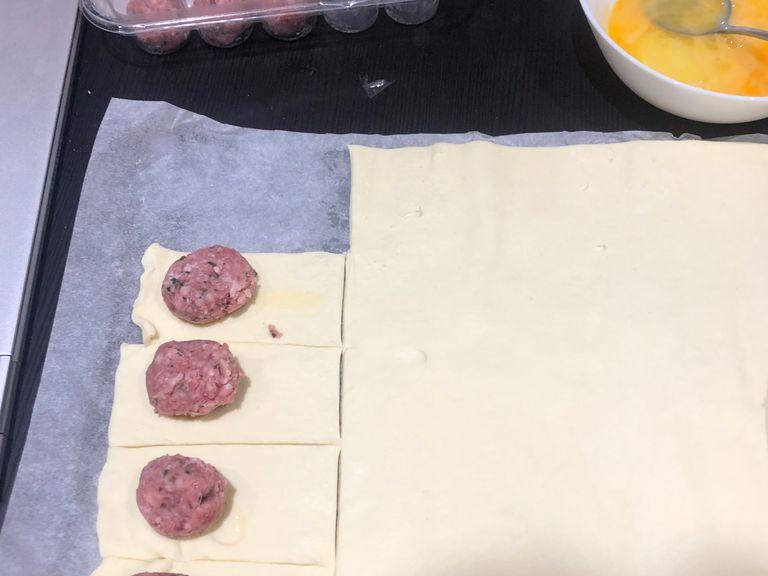 Put meatball on to each square and roll into a small ball (add cheese)