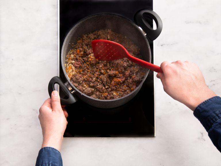 Heat the oil in a large pot and sauté the garlic, onions, carrots, and celery root. Add the ground beef and sauté over medium heat for approx. 8 – 10 min., breaking it up with a spatula.