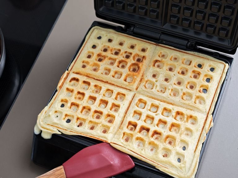 After 1 hr. resting, the waffle dough should have doubled in size. Preheat waffle iron and grease with some vegetable oil. Using a small ladle, add dough to waffle iron and bake for approx. 5 min. Repeat with remaining dough.