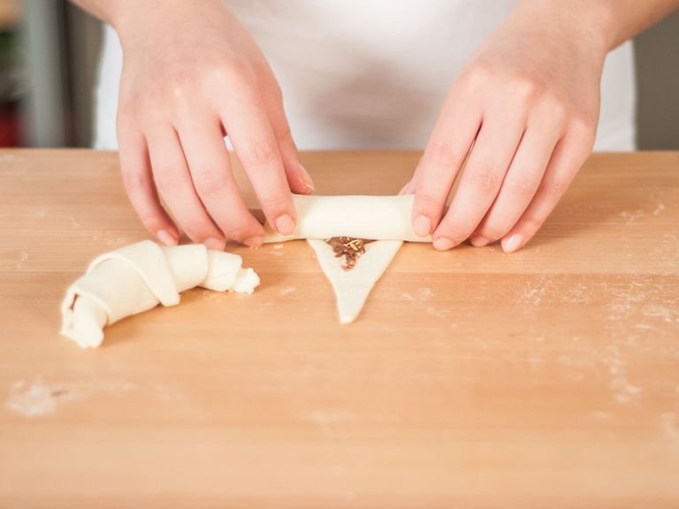 Roll the puff pastry forward, starting from the bottom.