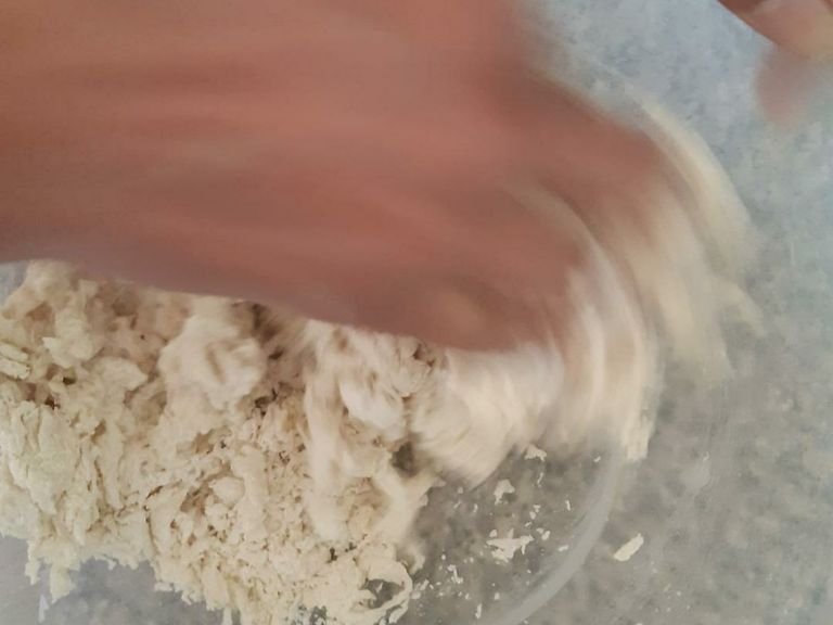 Add water little by little to the flour, making a stiff dough.