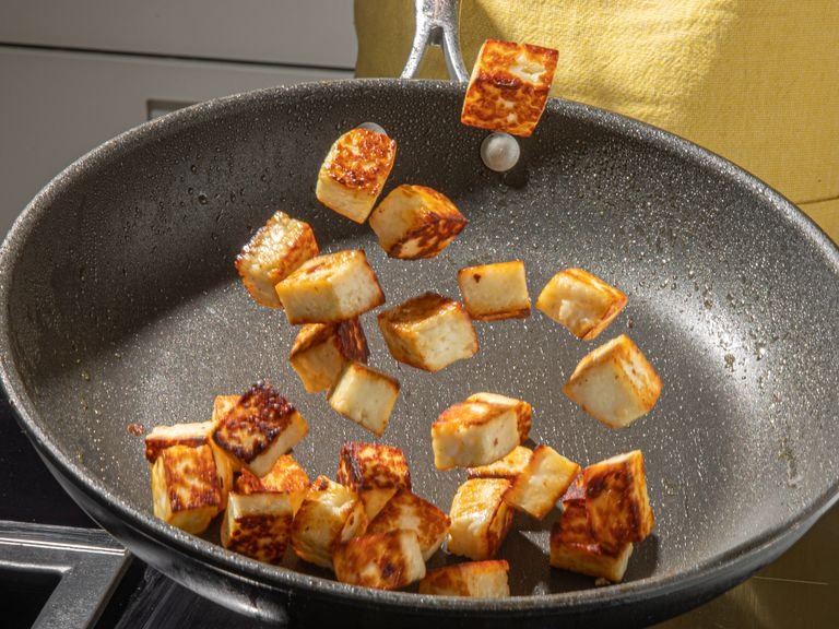 Heat a frying pan over medium high heat and add olive oil. Fry bread until crispy. Remove then sear halloumi on both sides until golden brown and crisp.