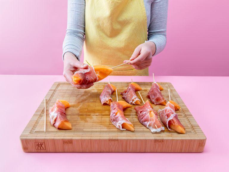 Wrap a piece of prosciutto around each melon wedge and skewer onto a wooden skewer.