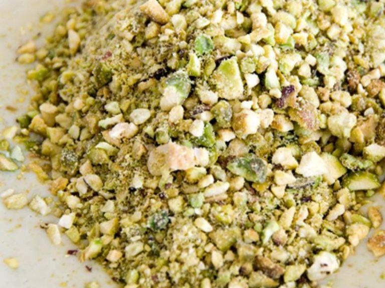 Chop the pistachios finely, or blitz in a food processor until in small chunks. Separate away 10 g of pistachios for garnish.