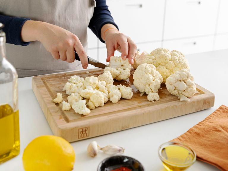 Preheat the oven to 350°F/180°C. Cut cauliflower into florets. Roughly chop parsley. Zest the lemon and grate the Parmesan cheese.