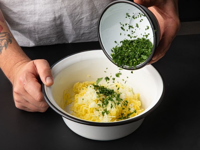 For the filling, very finely mince the onion and parsley. Press the potatoes through a potato ricer into a large bowl. Add onion, parsley, and cumin to the potato mixture, then season with salt and pepper and mix well.