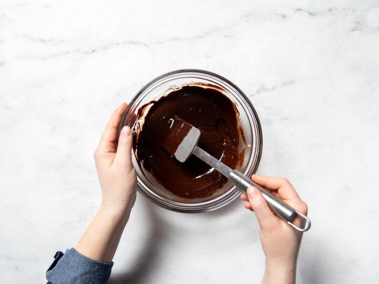 Mix the maple syrup, melted coconut oil, and melted dark chocolate in a bowl. Add the remaining cocoa powder and salt and stir with a whisk until combined.