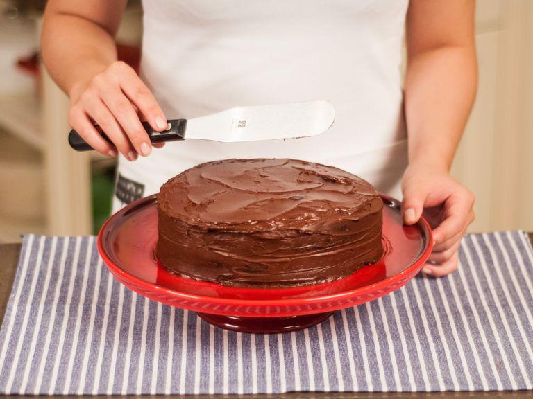 Place the second cake base on top and cover the whole cake with remaining chocolate ganache. Serve with a cup of coffee or tea.