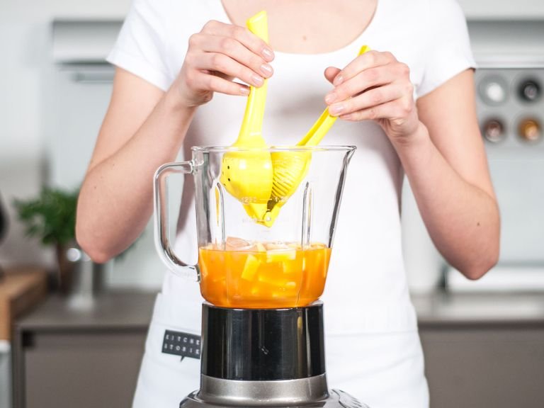 Add pineapple, ginger, carrot juice, orange juice, ice cubes, and honey to blender. Add lime juice.