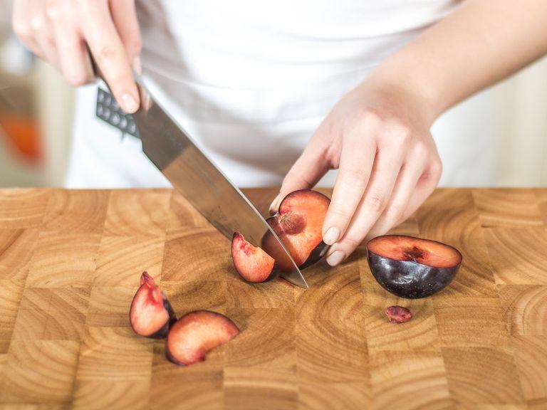 Preheat the oven to 200°C/400°F. Halve the plums, remove the pit and cut into wedges. Place in a baking dish.