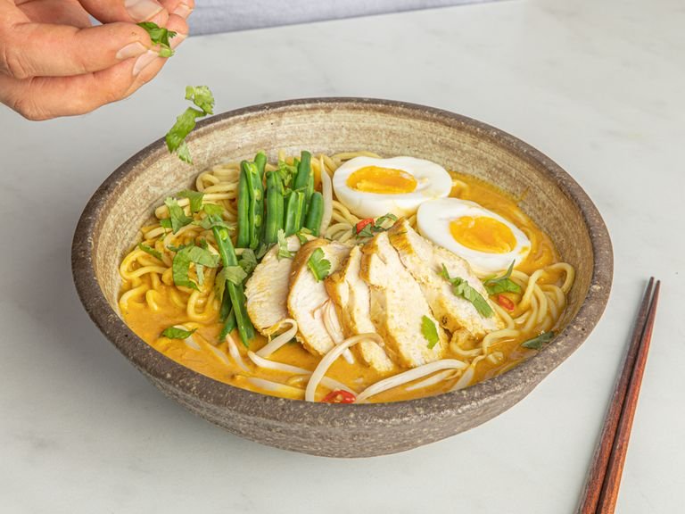 To serve, divide the noodles, chicken, and egg between the bowls and fill up with soup. Garnish with cilantro (and bean sprouts, if desired) and extra Thai chili if desired. Serve with lime, cut into wedges. Enjoy!