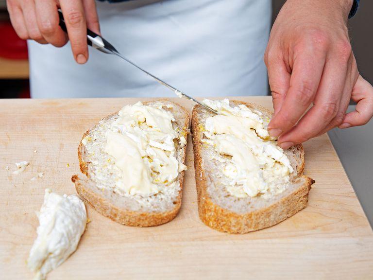 To assemble, spread garlic butter onto one side of half the slices of bread. Zest lemon over each slice. Place camembert slices on top of two slices, then the blueberries, and the basil leaves. Place the top slice of bread over the sandwich, butter and lemon zest side-down.